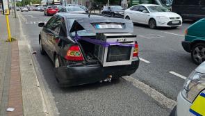 Recipe for disaster: Phone-using driver with oven hanging out of the boot has car seized
