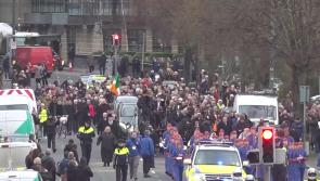 WATCH: Mourners gather as Artane Band leads funeral procession of Shane MacGowan