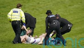 Animal activists taken away by police after running on to Epsom track