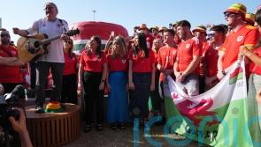 Wales fans gather for singalong as visa issues mean some risk missing Iran match