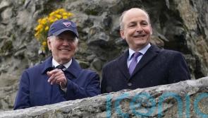 US president cheered by well-wishers waiting in the rain in Carlingford