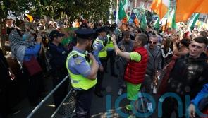 Gardai move in to disperse sit-down anti-immigration protest on Dublin bridge