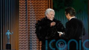 Jamie Lee Curtis presents SAG prize to Colin Farrell, saying he gave her Covid