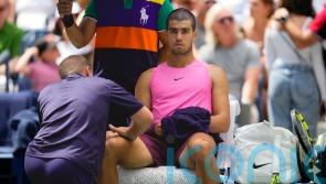 Carlos Alcaraz plays down concerns over knee issue after easing to victory