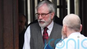 Gerry Adams arrives at High Court for bombings trial