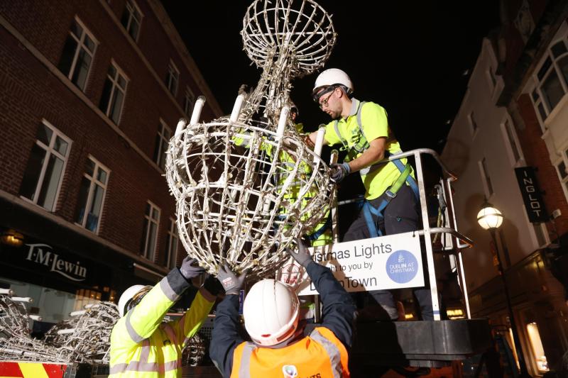 Workers begin hanging Christmas lights in Dublin City months before big day