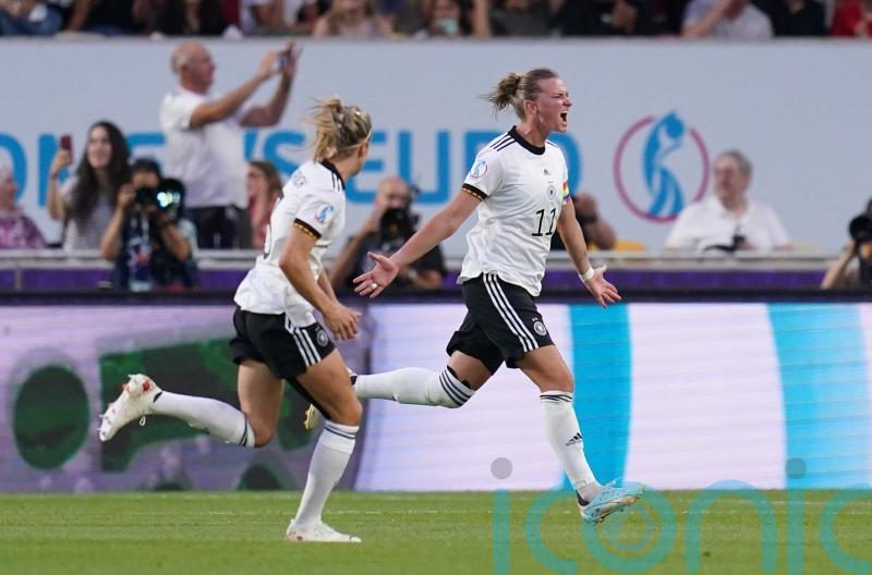 Germany ease to win over Spain to qualify as group winners
