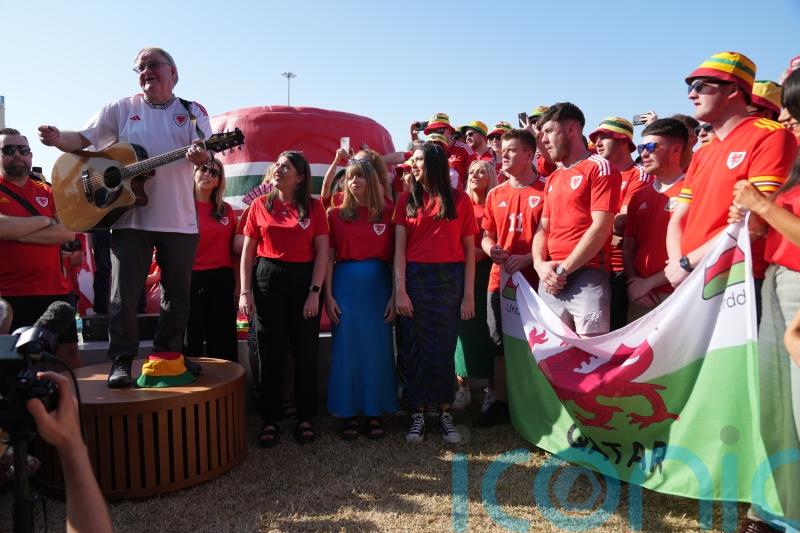 Wales fans gather for singalong as visa issues mean some risk missing Iran match