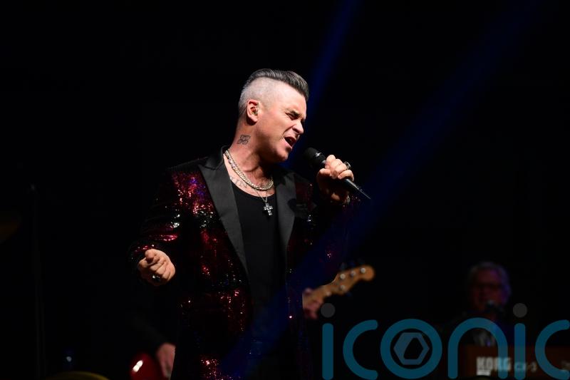 Let Me Entertain You: Robbie Williams plays World Cup gig for England squad