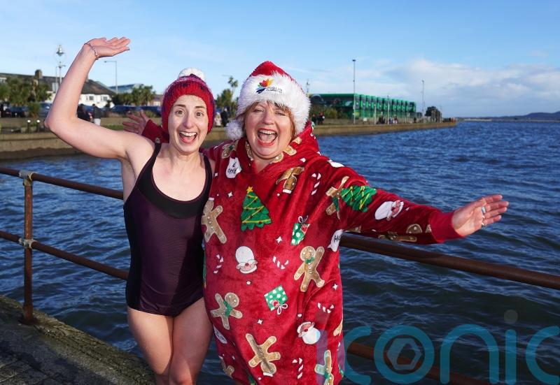 Hundreds of plucky swimmers brave chilly sea for charity