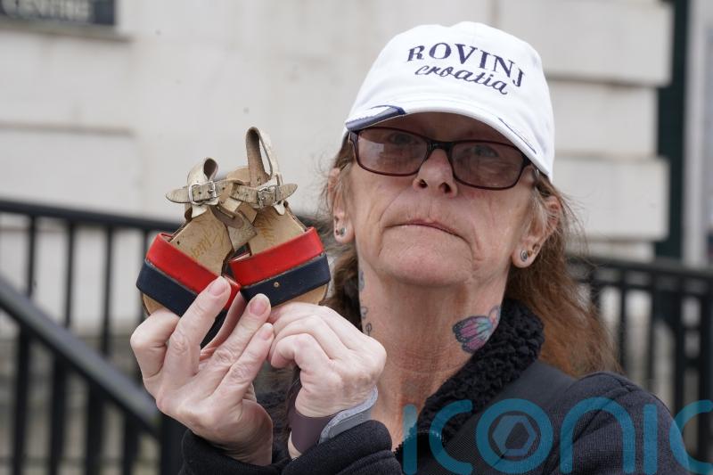 Bereaved family members lay shoes of loved ones in protest against legacy Bill