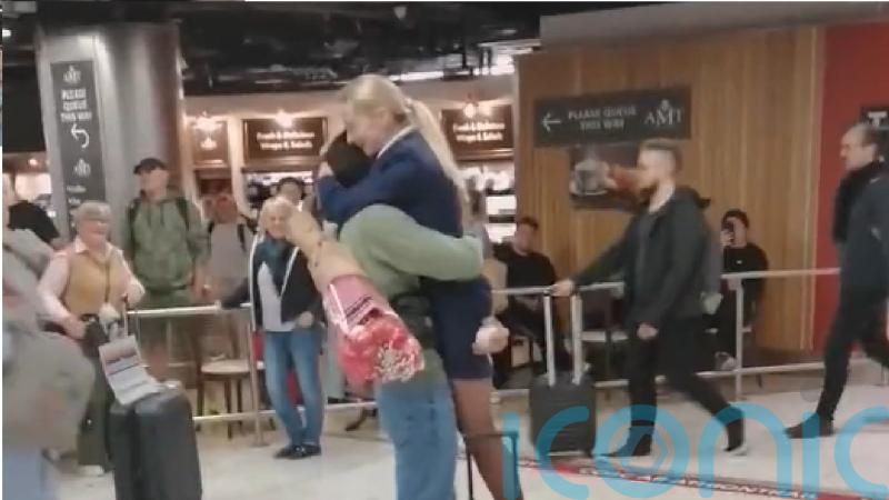 Crowd cheers as man proposes to flight attendant in Dublin Airport