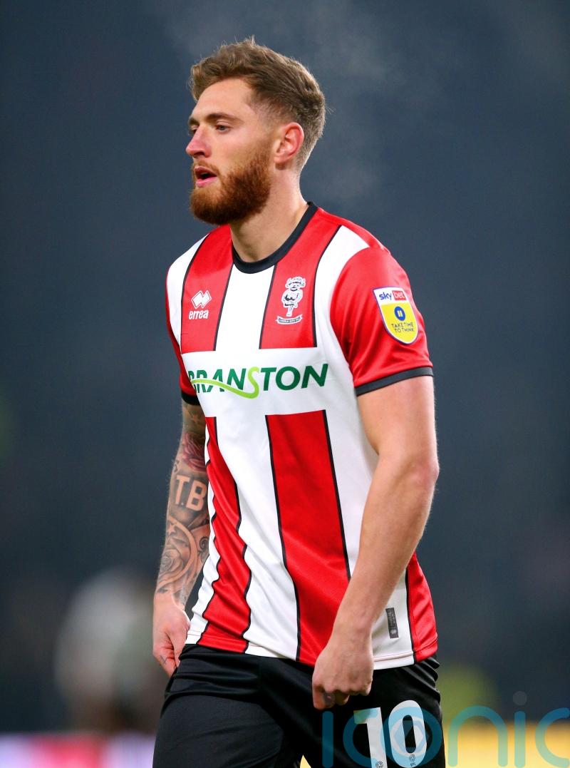 Lincoln move up to second with victory over 10-man Blackpool