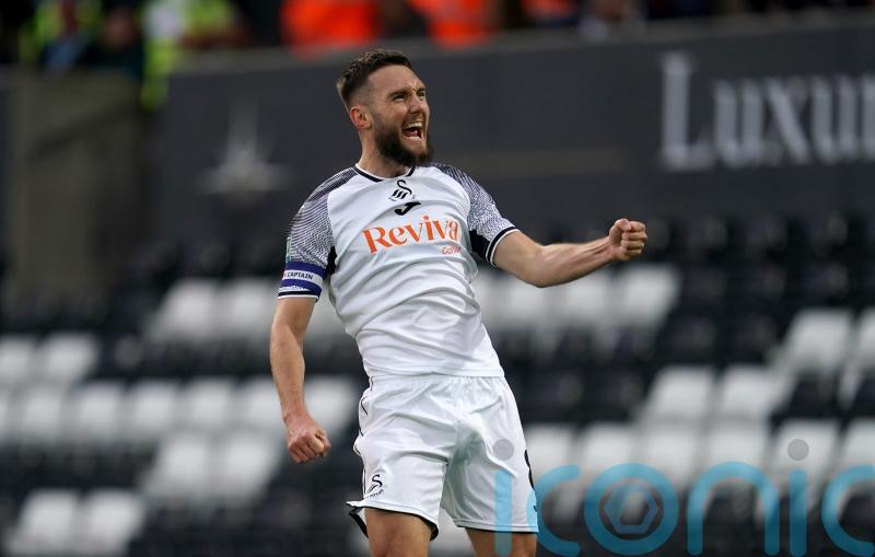 Swansea breeze to first league win of the season against managerless Preston