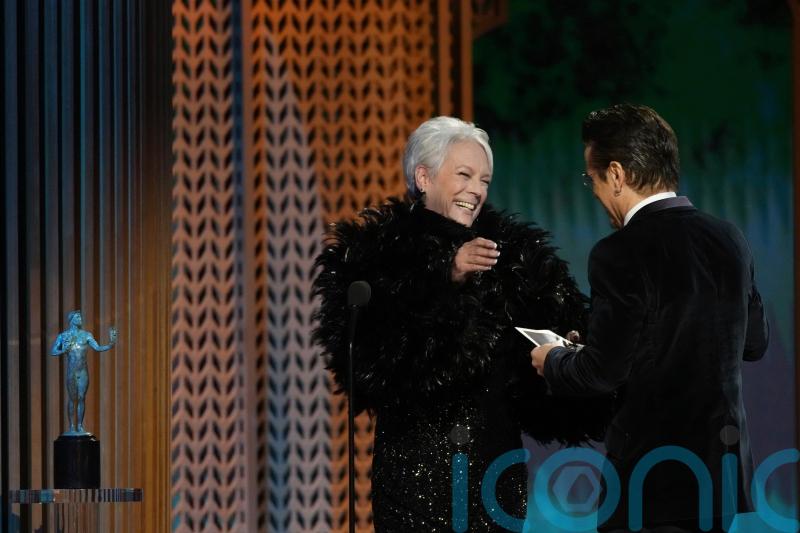 Jamie Lee Curtis presents SAG prize to Colin Farrell, saying he gave her Covid